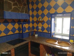 a bathroom with a sink and a window at La posada del Mozarabe in Alquife +3 photos