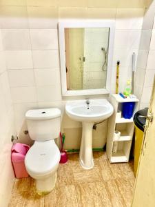 a bathroom with a toilet and a sink at T1 - Mutamba , Luanda, Angola - Centro da Cidade in Luanda