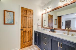 a bathroom with two sinks and a large mirror at Private Beach Access and Hot Tub Kitty Hawk Haven in Kitty Hawk +35 photos