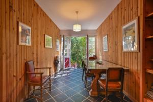 a dining room with wooden walls and a table and chairs at Petit Colibri - Proche de la plage in La Baule