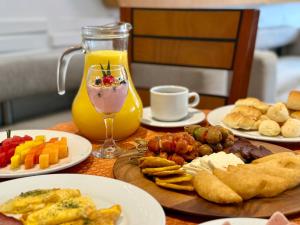 a table topped with plates of food and a drink at Hotel Atrium Plaza in Barranquilla