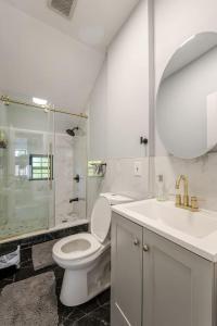 a bathroom with a toilet and a sink and a shower at Modern House in Black Rock in Bridgeport +19 photos