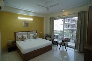 a bedroom with a bed and a large window at Hotel The Luxe 18 - Golf Course Road in Gurgaon