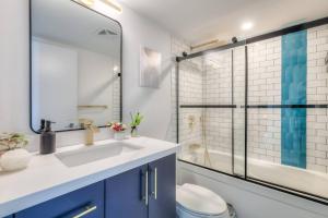a bathroom with a sink and a toilet and a shower at Chic 1BR plus Den Condo with Fast WiFi and Free Parking in Toronto +17 photos