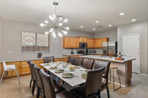 a dining room and kitchen with a table and chairs at Mountain View Retreat Pool, Firepit Pool table Fun in Casa Grande
