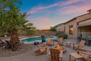 a backyard with a fire pit and chairs and a pool at Mountain View Retreat Pool, Firepit Pool table Fun in Casa Grande