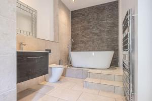 a bathroom with a tub and a toilet and a sink at Balbirnie Mill, Brechin. in Angus +74 photos