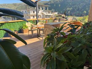 a balcony with a table and chairs and plants at Guest House Toska in Berat