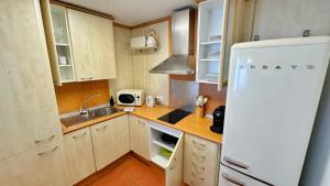 a kitchen with a sink and a refrigerator at Nomad Haux in the heart of Tossa 7 in Tossa de Mar