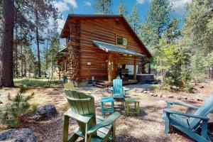 a log cabin with rocking chairs in front of it at Sunriver Log Cabin in Bend