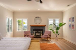 a living room with a bed and a fireplace at The Grape Escape Panoramic Views In Wine Country in Temecula +101 photos