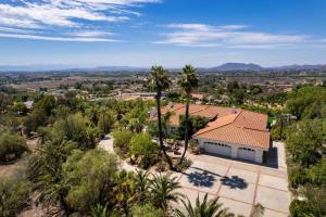 an aerial view of a house with palm trees at The Grape Escape Panoramic Views In Wine Country in Temecula