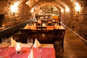 a restaurant with tables and chairs with wine glasses at Linde Restaurant & Hotel in Nußloch