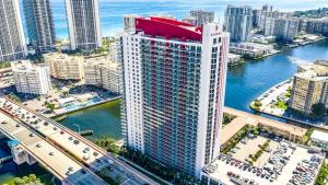 an aerial view of a tall building near the water at 1br BeachWalk Ocean View in Hallandale Beach