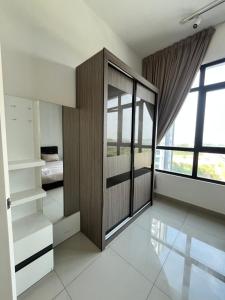 a bedroom with a large wooden closet and a bed at Arinara 2 Homestay 3Bed 2Bath 6 pax Conezion Ioi Putrajaya in Serdang +15 photos