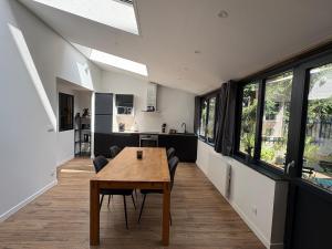 a kitchen and dining room with a wooden table at L'Atelier du Prince in Verdun