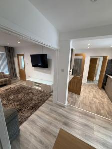 ein Wohnzimmer mit einem Flachbildfernseher an der Wand in der Unterkunft 3 Bed Home From Home Contractor & Family Stay DY5 in Woodside