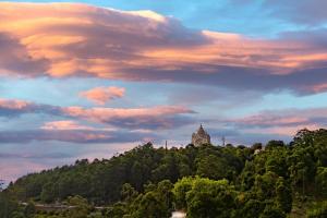a building on top of a hill with trees at Villa Luzia by Portugal Active in Viana do Castelo