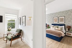 a bedroom with a bed and a chair at Pimlico gem Central London next the London Eye in London