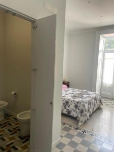 a bedroom with a bed and a bathroom with a window at La Casa del Poeta 2 in Mercato San Severino