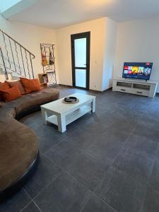 a living room with a couch and a coffee table at La Félicita-Independent House-Terrace-8 Pers in Saint-Jean-de-Maurienne