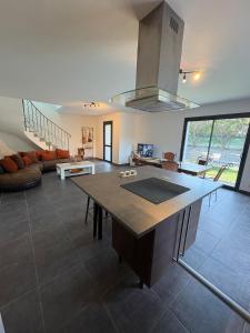 a kitchen and living room with a large island in a house at La Félicita-Independent House-Terrace-8 Pers in Saint-Jean-de-Maurienne