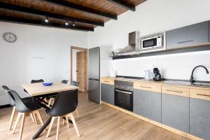 a kitchen and dining room with a table and chairs at Home2Book Rustic Stone Haven with Terrace in La Guancha