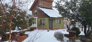 a small house with snow on the ground at Lo de Pere in San Carlos de Bariloche