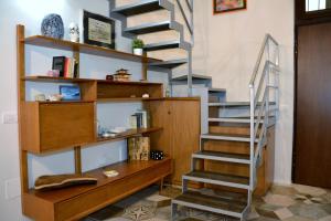 a spiral staircase in a room with a book shelf at Exclusive Suite San Biagio 25 in Naples