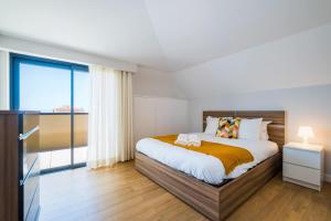 a bedroom with a bed and a large window at The Shoreline 4 by Portugal Portfolio in Parede