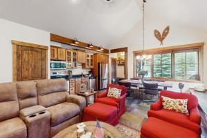 a living room with a couch and chairs and a table at Cozy Cabin Retreat in Grand Lake