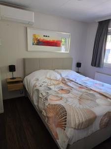 a bedroom with a bed with a shell on it at Chalet Dune chaletpark krabbenkreek Sint Annaland in Sint Annaland +44 photos