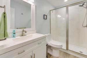 a white bathroom with a shower and a toilet at 5 Mi to Dtwn Beaufort Home with Screened-In Patio in Port Royal +16 photos