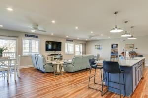 a living room with chairs and a kitchen and a table at Private Dock, Fire Pit Lake Murray Family Escape! in Lake Murray Shores