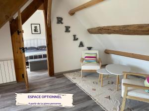 a room with a table and chairs and a bed at Little Paradise - Comfort and Quiet Getaway by the Eure in Montreuil