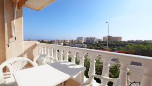a white balcony with a white table and chairs at R-2428 APARTAMENTO CORINTO in La Mata