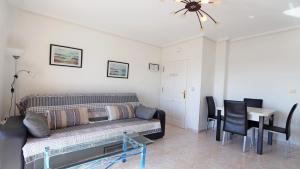 a living room with a couch and a table at R-2428 APARTAMENTO CORINTO in La Mata +8 photos