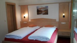 a bedroom with two beds in a room at Haus Talblick in Curon Venosta