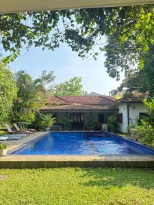 a swimming pool in the yard of a house at Ali Bungalow - Galle in Galle