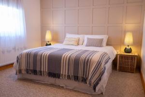 a bedroom with a large bed with two lamps at SeaBreeze Portstewart in Portstewart