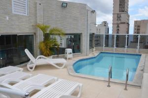 a swimming pool on the roof of a building at Atlantico Flat Santos in Santos