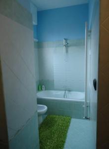 a bathroom with a white tub and a toilet at I colori della casa di Gio in Grugliasco +11 photos