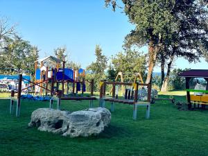 a playground with a rock in the grass at Skyline 11B Apartment - Sea View,Pools & SPA in Varna City
