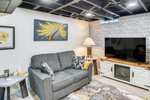 a living room with a couch and a flat screen tv at 2 Mi to Lake Michigan Family-Friendly Home in Manitowoc