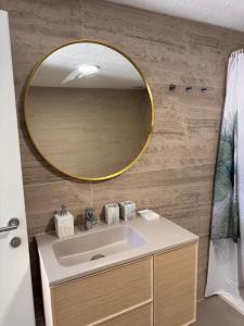 a bathroom with a sink and a gold mirror at Villa Zvonimir in Suknovci