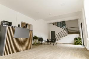 a living room with a staircase and a table at Pensiunea Arkara in Târgu-Mureş