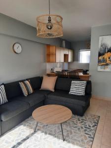 a living room with a black couch and a table at Pips Place 203 in Strand