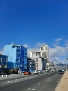 a highway with cars driving down a street with buildings at Pips Place 203 in Strand