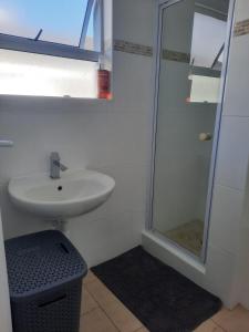 a bathroom with a sink and a shower at Pips Place 203 in Strand +30 photos