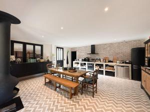 a kitchen with a table and chairs in a room at Charmante maison de ville avec vue sur le donjon avec wifi et jardin in Gouffern en Auge